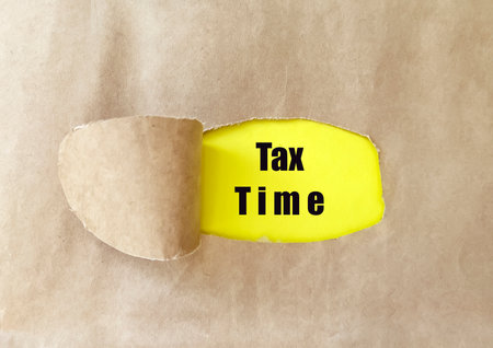 Torn paper with TAX TIME text. Business concept image.の写真素材