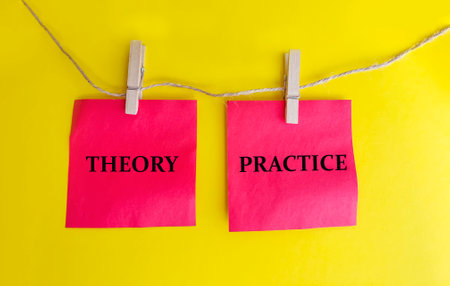 Theory and Practice words on sticky notes hanging on a rope.の写真素材