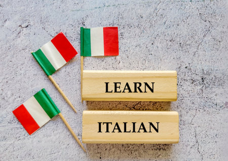 Learn italian text on wooden blocks with Italy flag on concrete backgroundの写真素材