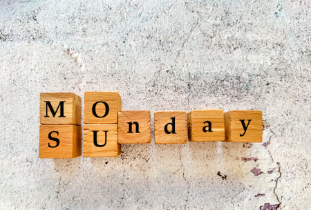 The word 'Monday' on wooden cubes on a concrete background.の写真素材