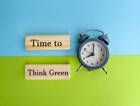 Time to think text on wooden blocks with alarm clock on colorful backgroundの写真素材