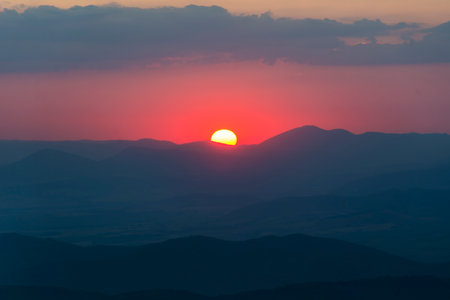 Sunset in the mountains. Sunrise over the mountain range. Beautiful natural landscape.の写真素材