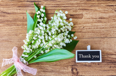 Bouquet of lily-of-the-valley flowers on wooden backgroundの写真素材