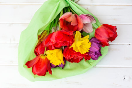 Bouquet of colorful tulips on a white wooden background.の写真素材
