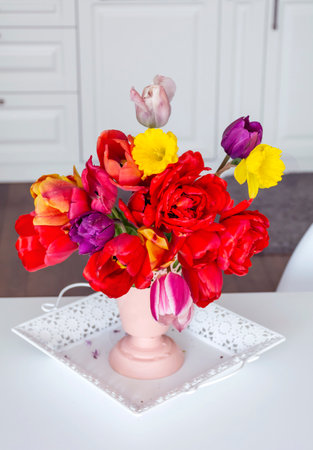 bouquet of tulips in a vase on the tableの写真素材