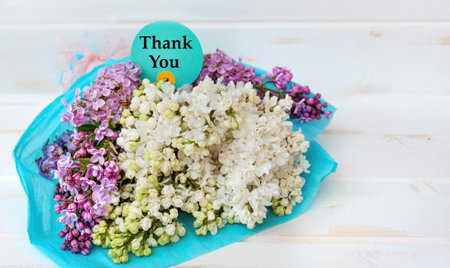 Bouquet of white lilac and blue card with thank youの写真素材