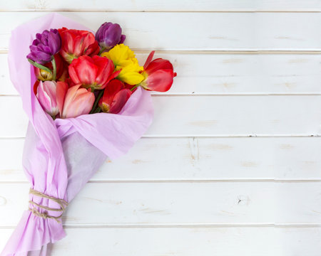 Bouquet of tulips on a white wooden background with copy spaceの写真素材