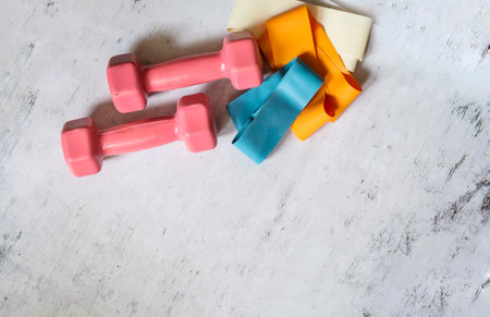 Dumbbells and tape on a white background.の写真素材
