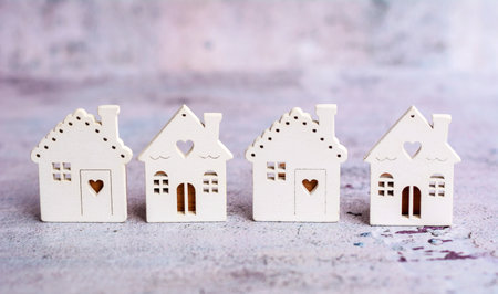 Miniature houses in the form of hearts on a rustic backgroundの写真素材