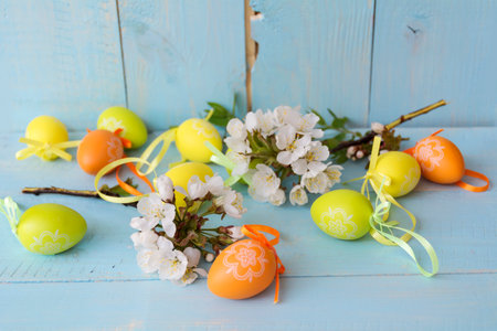 Easter eggs and spring blossom on a blue wooden background.の写真素材