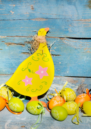 Easter eggs and chicken on wooden background. Happy easter!の写真素材