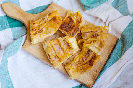 Apple strudel on a wooden board, square image, top viewの写真素材