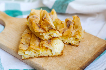 Puff pastry with apple filling on a wooden board, selective focus.の写真素材