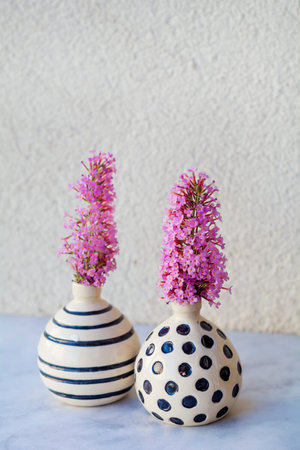 Purple flowers in vases on a white background. Retro style.の写真素材