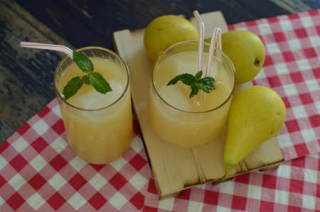 Homemade pear juice on the wooden table.の写真素材