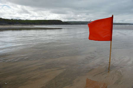 Red flag on the beach.の写真素材