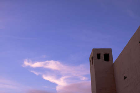 Spanish style stucco building tower against a dusk skyの写真素材