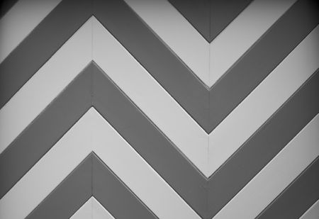a black and white chevron or zig zag wood design of a garage door on an older homeの写真素材