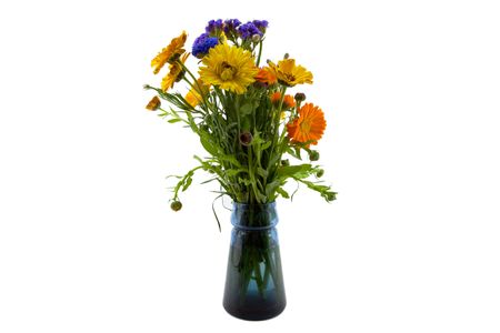 Bouquet of Yellow Orange Blue Flowers in a clear blue glass vaseの写真素材