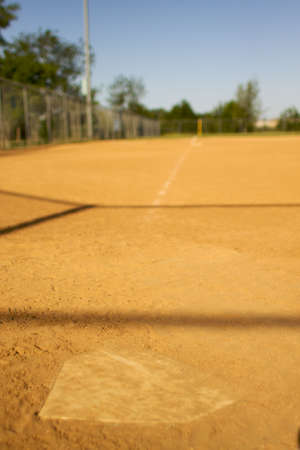 short depth of field shot of home plate looking towards third base