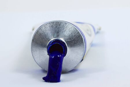 Ouzing paint from a blue oil paint tubes の写真素材