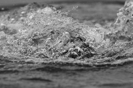 Close up of bubbling water in a fountain done as black and white imageの写真素材