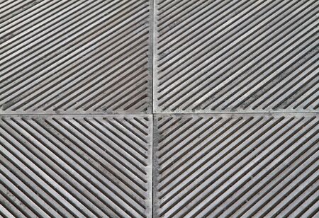 sidewalk steel grating with mezmerizing pattern of holesの写真素材