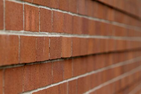 Red brick wall on buliding done in perspective trailing to soft focusの写真素材