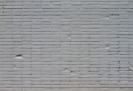 Close-up of a brick wall that has been painted gray from distanceの写真素材