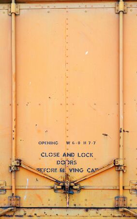Yellow Orange old railroad car door and latchの写真素材