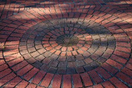 Circles of different colored and sized red bricksの写真素材