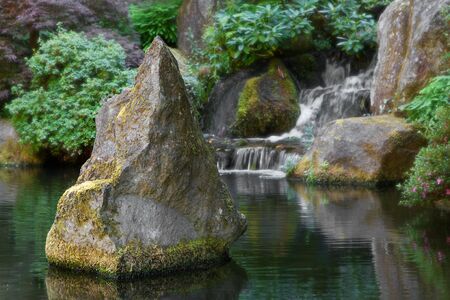 Spiked Boulder in the middle of a  Waterfall pondの写真素材
