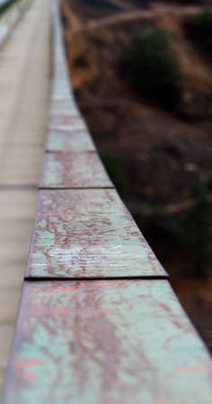 Road and pedestrian walk on bridge with green metal gaurd railsの写真素材