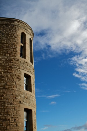 Windowed Stone tower of Port Townsend Post Office against Blue sky with cloudsの写真素材