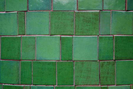 Close up of a section fo glazed green tiles on a curved wallの写真素材