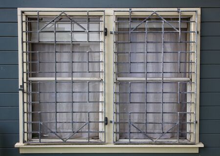 Metal barred or grated security installed on two windows