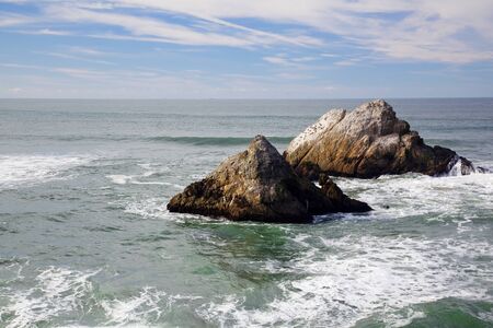 Ocean Rock outcrops with waves and blue skyの写真素材
