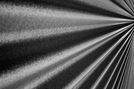 Black and white image of a steel metallic corrugated wall converging to a point on the rightの写真素材