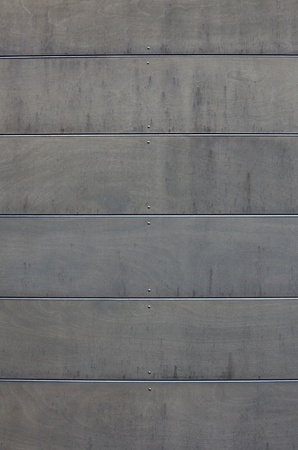 Gray wood grained concrete wall with horizontal sections