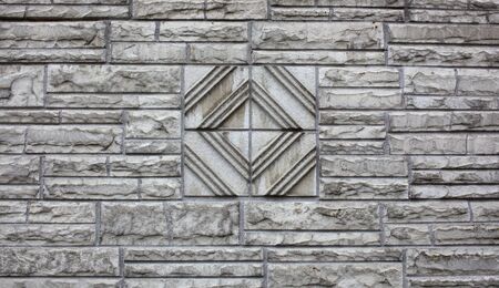 Wall of white stone shaped bricks with a unique rotated square designの写真素材