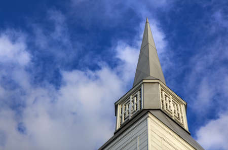 Simple gray Simple Metal Church Steeple with blue and white sky background done as a subtle HDR imageの写真素材