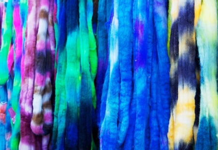 Blue, violet, yellow, green, and white strands of un-woven yarnの写真素材