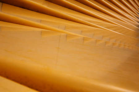 Abstract shot of a mustard yellow curved stepped surfaceの写真素材