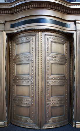 Large curved brass closed doors on a bank entranceのeditorial素材