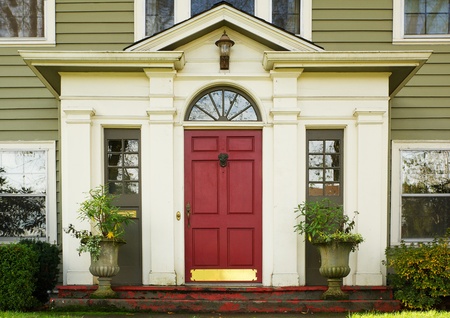 Magenta Home door bordered by two large potted plantsのeditorial素材