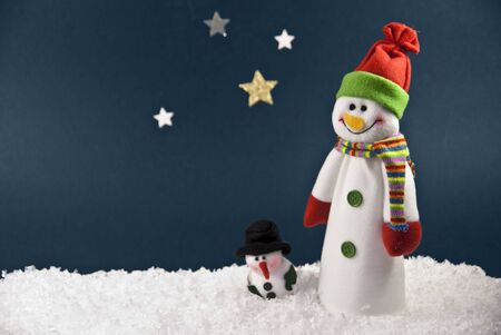 Two Snowmen against a Blue Night Sky with room for your writingの写真素材