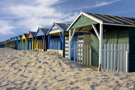Beach Cabins on a sandy beach on a sunny day with a blue skyの写真素材