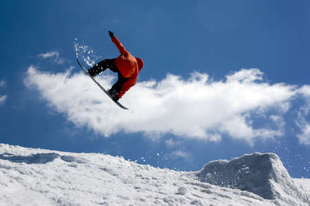 Snowboarder jump from snow- ramp.の写真素材