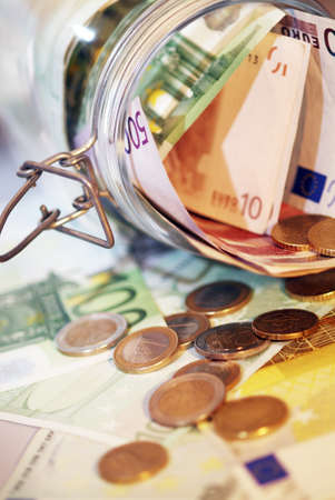 A Money jar full of money .Shallow focus.の写真素材
