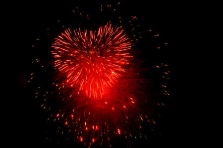 Red fireworks in the night sky in the form of heart の写真素材